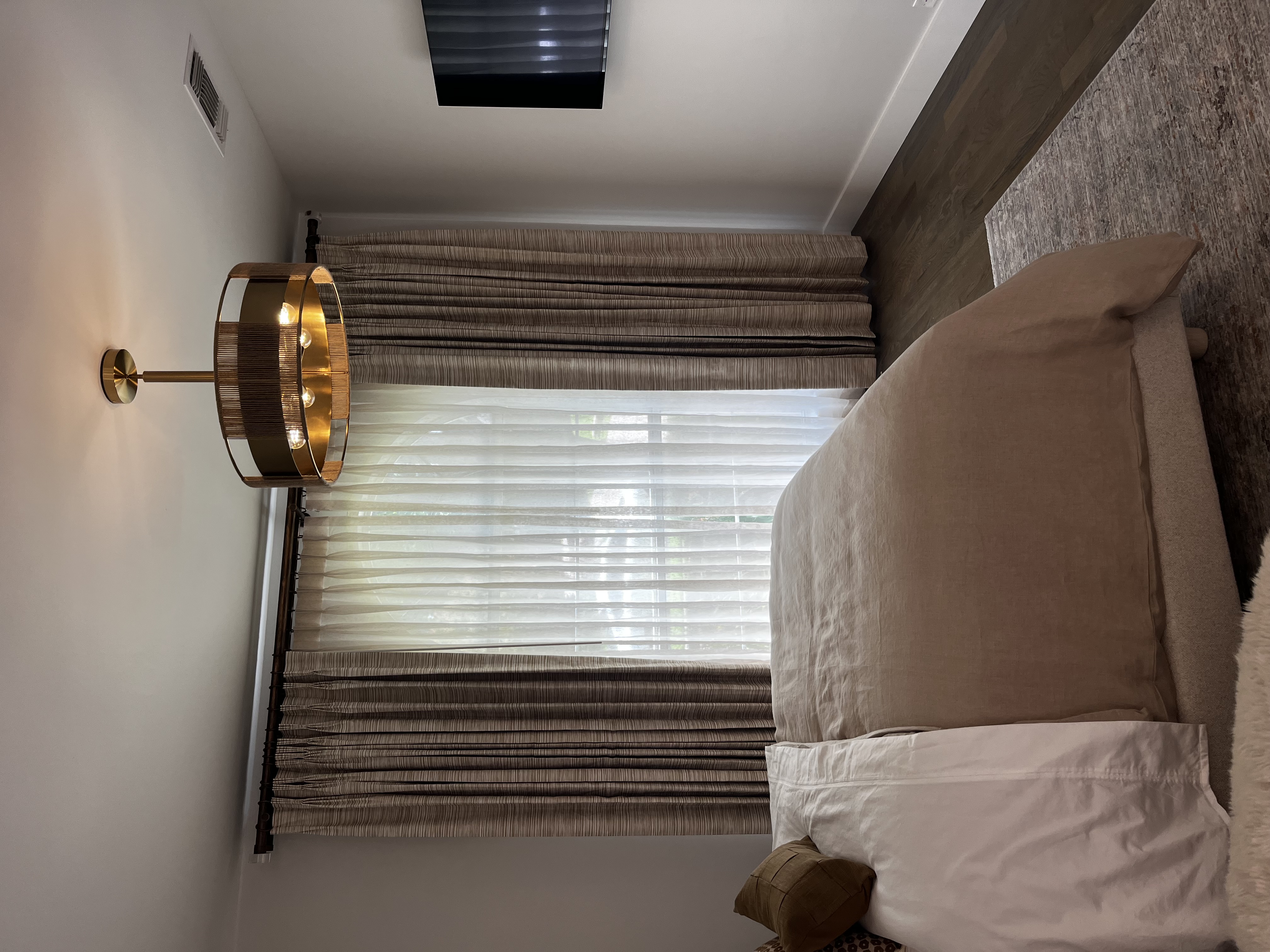 tan and white curtains in bedroom with tan bed comforter